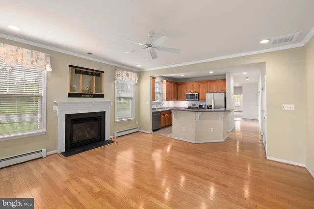 a kitchen with stainless steel appliances granite countertop a refrigerator stove and sink