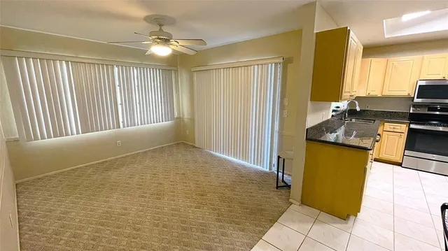 a kitchen with stainless steel appliances granite countertop a refrigerator and a stove top oven