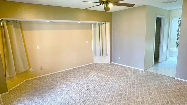 a view of an empty room with a window