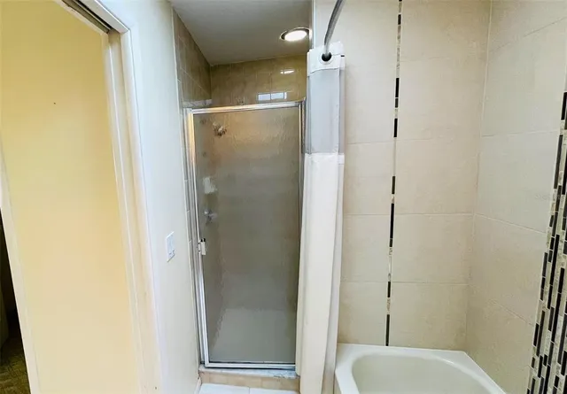 a bathroom with a shower and toilet