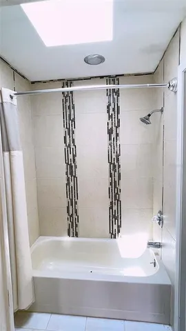 a bathroom with a bathtub and a shower