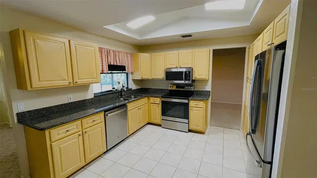 a kitchen with a sink appliances and cabinets