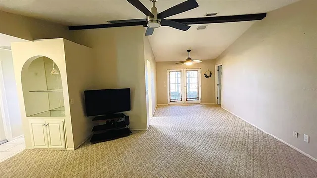 a view of a livingroom with furniture and a flat screen tv