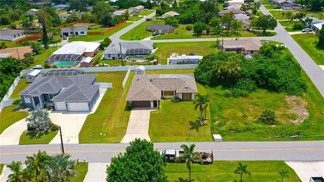 an aerial view of residential houses with outdoor space and street view