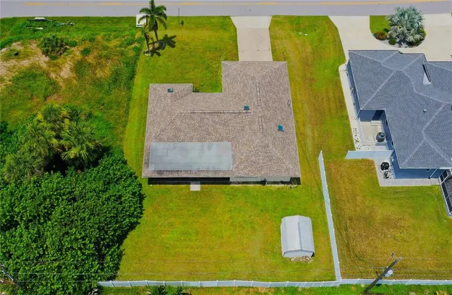 an aerial view of a house with a swimming pool