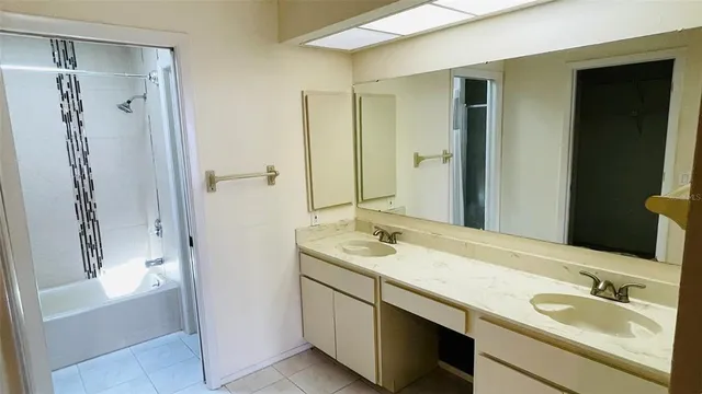 a bathroom with a granite countertop sink mirror and double