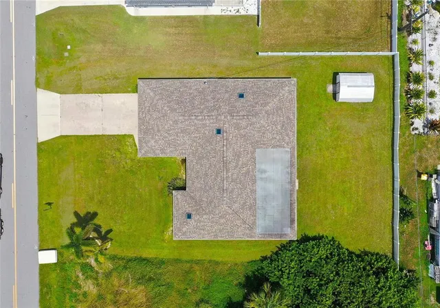 an aerial view of a house with a yard