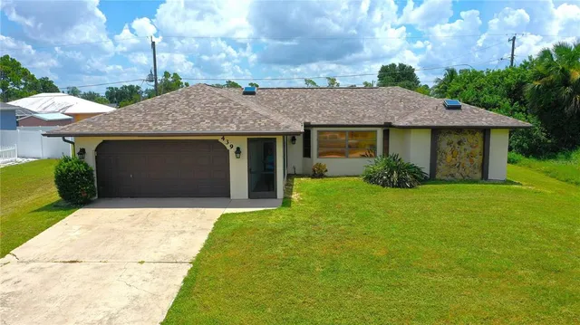 a front view of a house with a garden