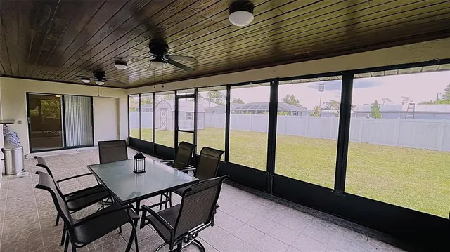a view of a dining room with furniture and window