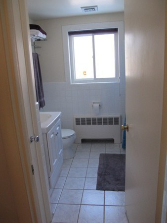 36 Edwardel Road Needham, MA 02492 - Photo 8 of 18 a bathroom with a sink a toilet and a window
