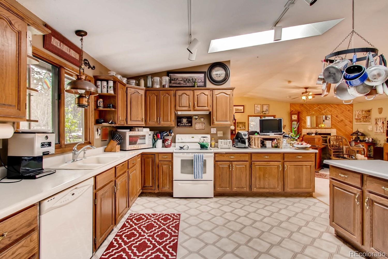8060 Cyprus Road Colorado Springs, CO 80908 - Photo 12 of 28 a kitchen with lots of appliances and cabinets