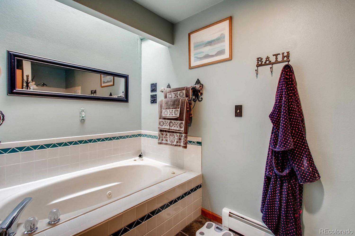 8060 Cyprus Road Colorado Springs, CO 80908 - Photo 16 of 28 a bathroom with a bathtub and a sink