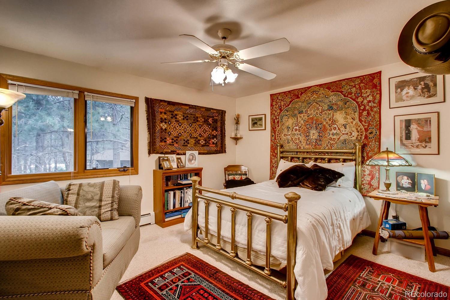 8060 Cyprus Road Colorado Springs, CO 80908 - Photo 17 of 28 a bedroom with two beds and a large window