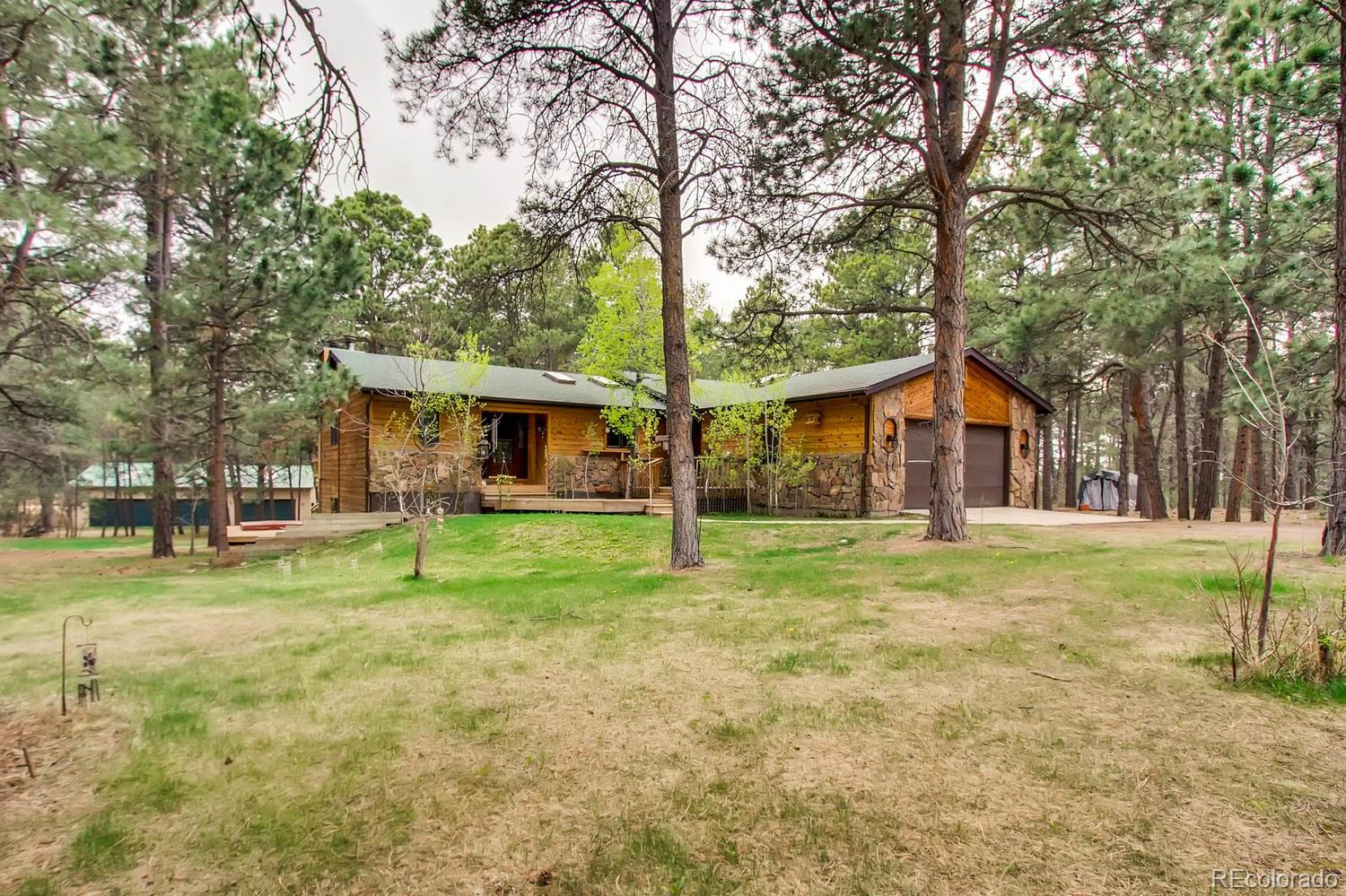 8060 Cyprus Road Colorado Springs, CO 80908 - Photo 2 of 28 a front view of house with a garden and trees