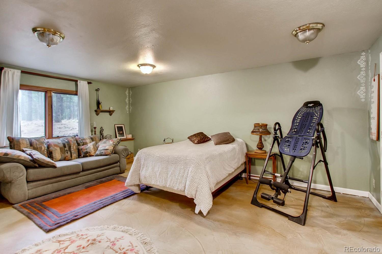 8060 Cyprus Road Colorado Springs, CO 80908 - Photo 21 of 28 a bedroom with a bed and a window