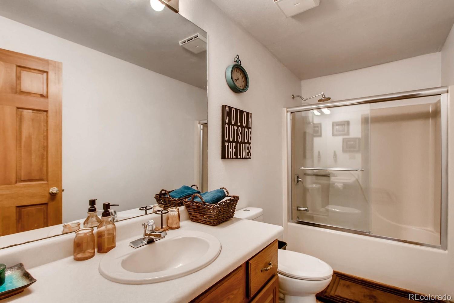 8060 Cyprus Road Colorado Springs, CO 80908 - Photo 23 of 28 a bathroom with a sink toilet and shower