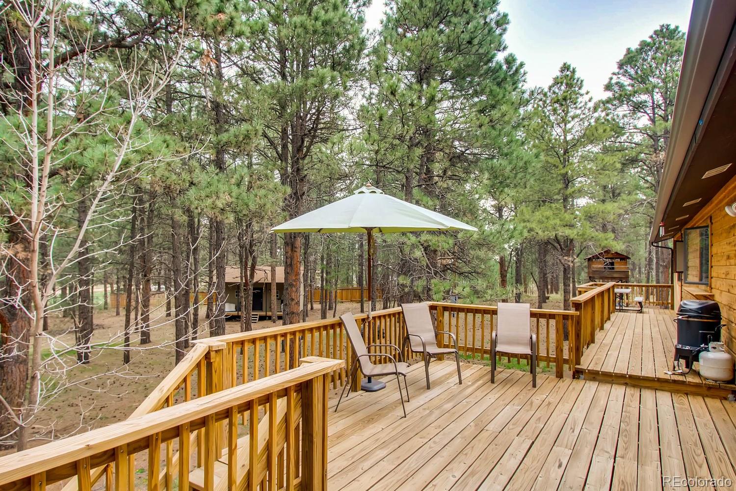 8060 Cyprus Road Colorado Springs, CO 80908 - Photo 25 of 28 a view of balcony with wooden floor and outdoor seating