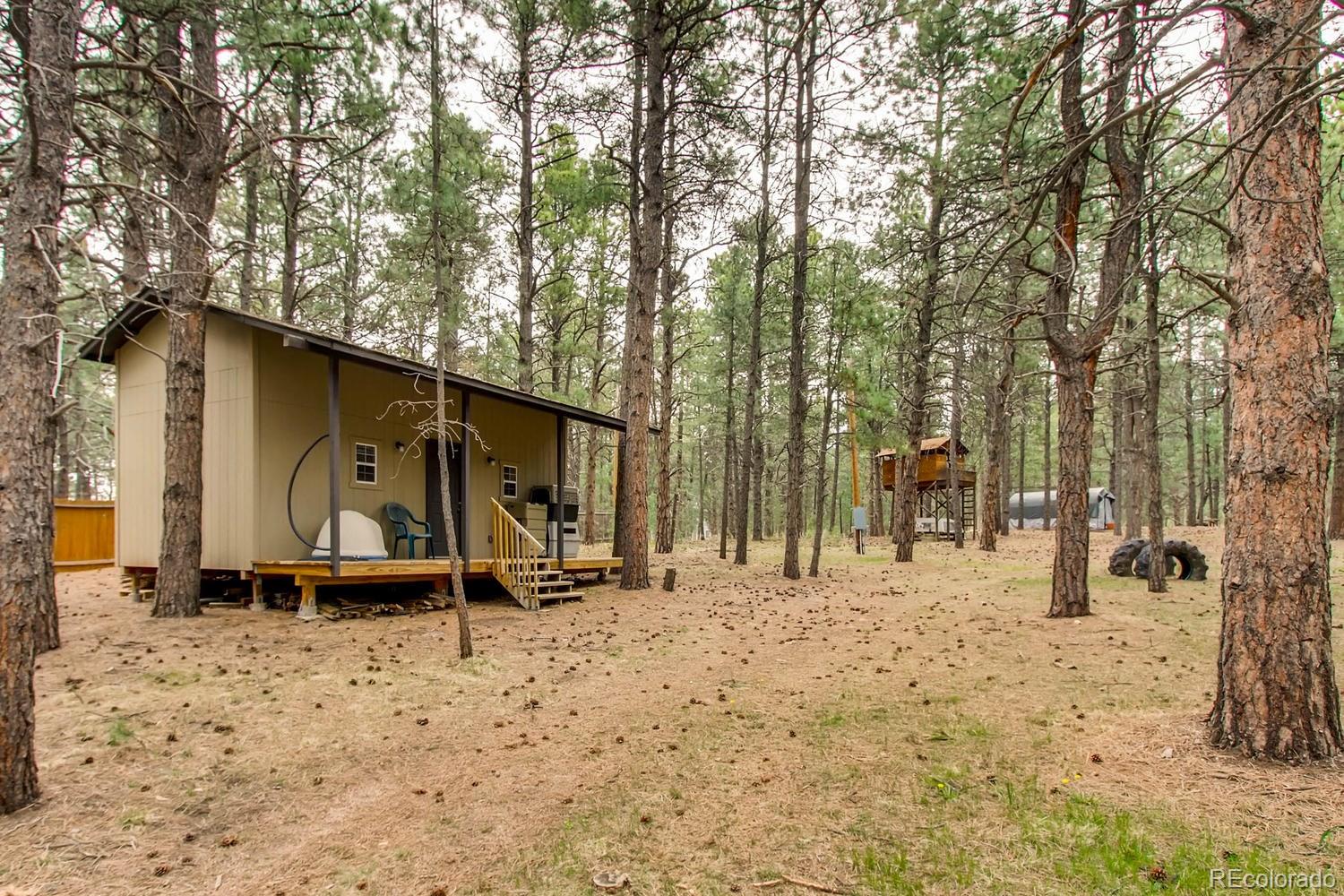 8060 Cyprus Road Colorado Springs, CO 80908 - Photo 26 of 28 a view of a wooden house with a yard