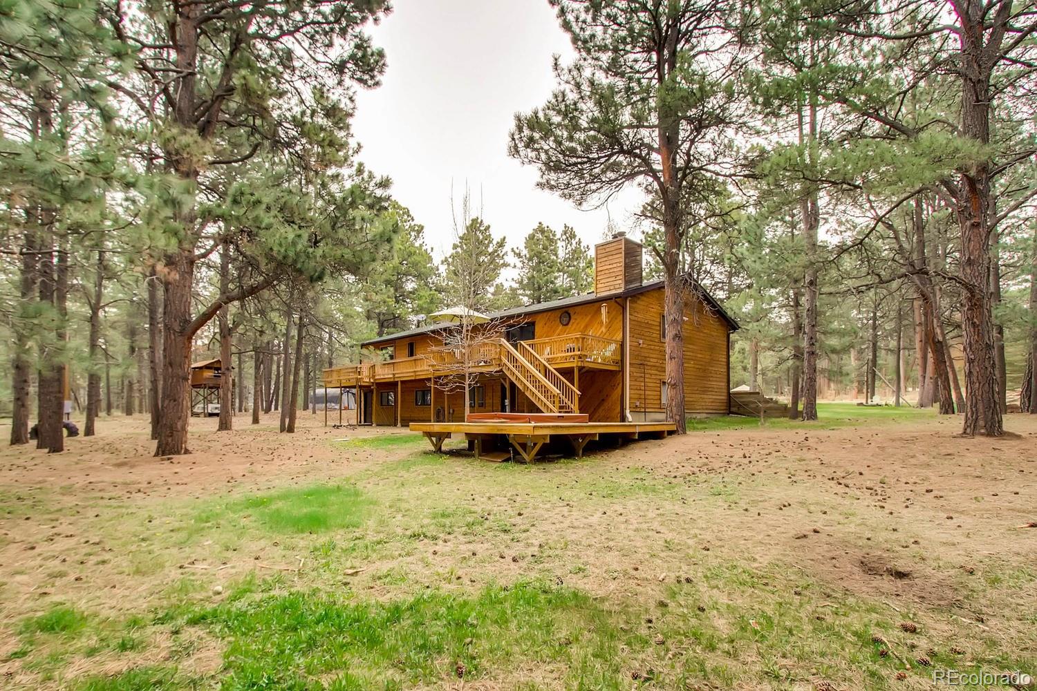 8060 Cyprus Road Colorado Springs, CO 80908 - Photo 27 of 28 a view of a yard with a house and large trees