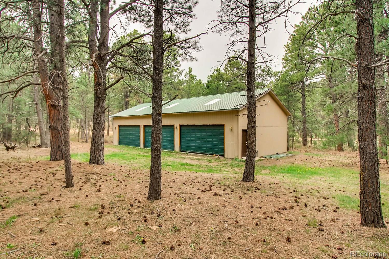 8060 Cyprus Road Colorado Springs, CO 80908 - Photo 28 of 28 a view of a house with backyard of tree
