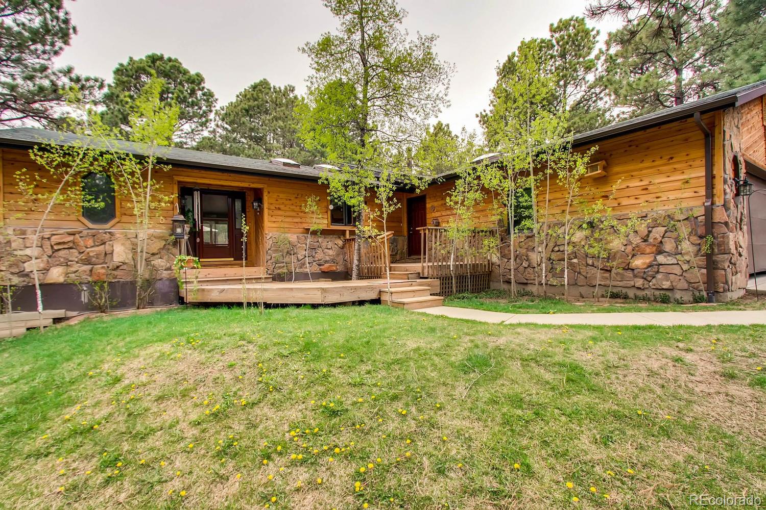8060 Cyprus Road Colorado Springs, CO 80908 - Photo 3 of 28 a front view of a house with a garden