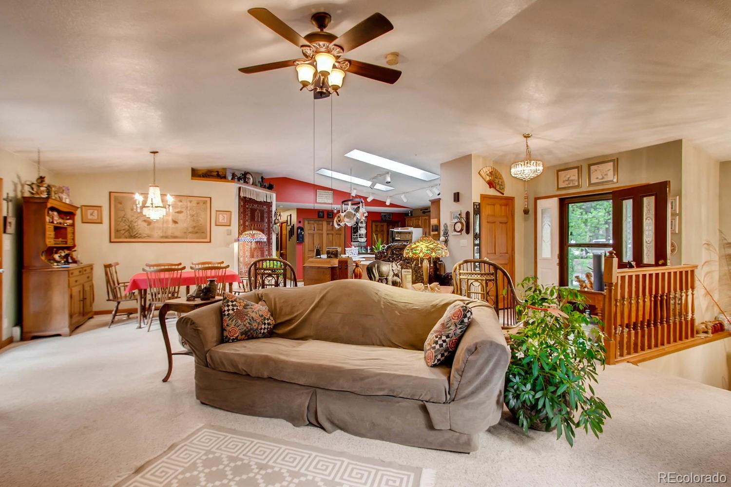 8060 Cyprus Road Colorado Springs, CO 80908 - Photo 6 of 28 a living room with furniture and a chandelier