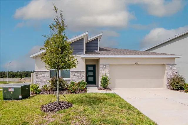a front view of a house with a yard garage and outdoor seating