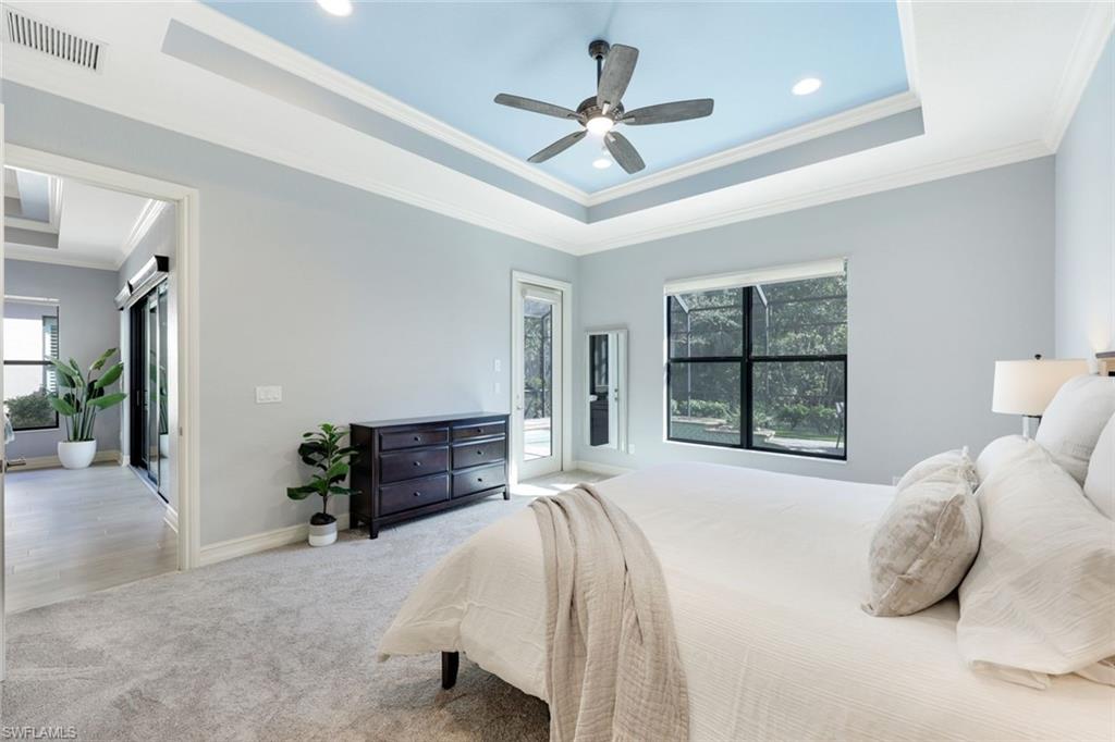 6592 Roma Way Naples, FL 34113 - Photo 15 of 41 Bedroom with a tray ceiling, crown molding, ceiling fan, new carpeting and access to lanai