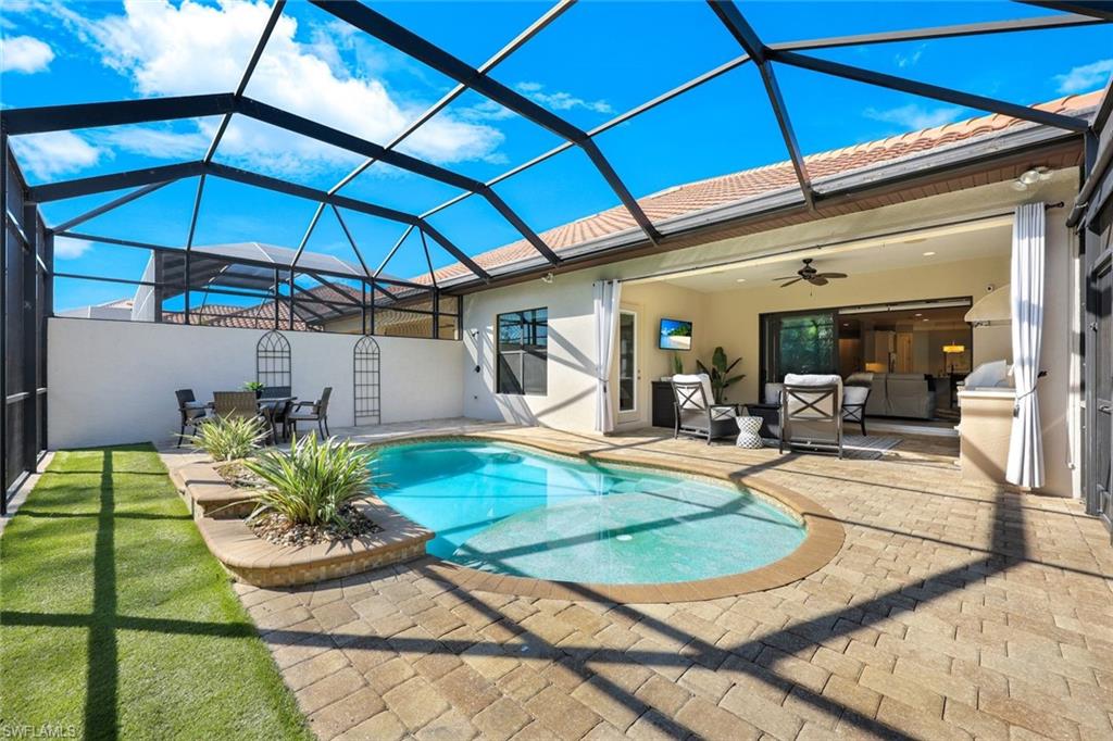 View of pool featuring an outdoor living space, ceiling fan and patio area