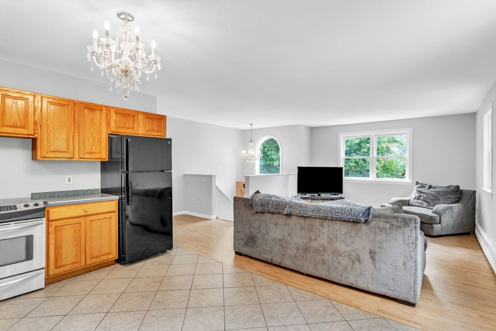 52 Warren Wright Road Belchertown, MA 01007 - Photo 12 of 41 a living room with furniture and a chandelier