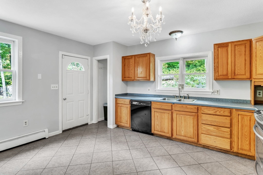 52 Warren Wright Road Belchertown, MA 01007 - Photo 13 of 41 a kitchen with stainless steel appliances granite countertop a stove sink and cabinets