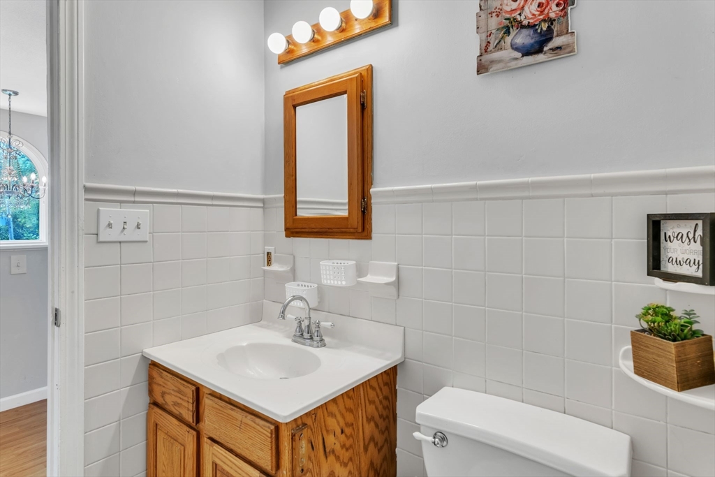 52 Warren Wright Road Belchertown, MA 01007 - Photo 17 of 41 a bathroom with a sink toilet and vanity