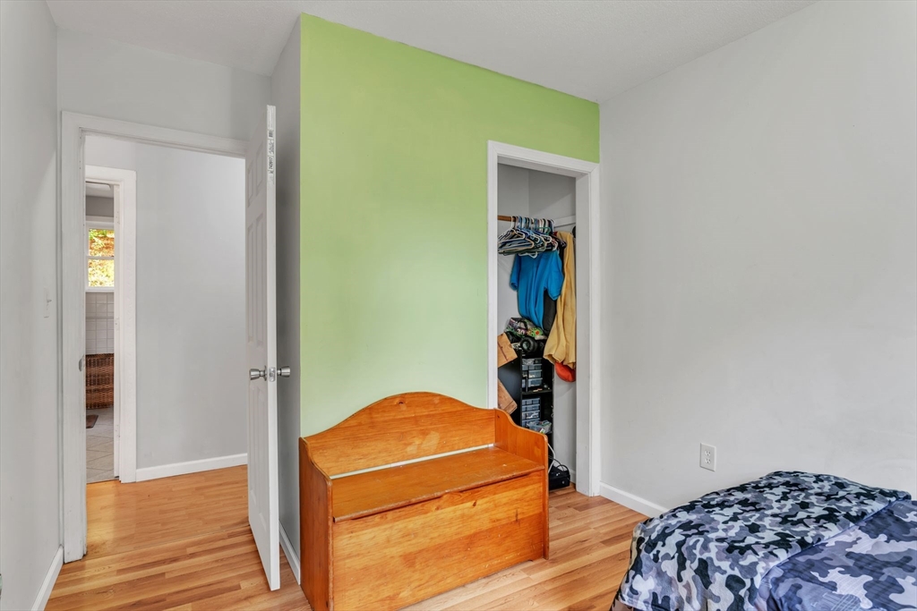 52 Warren Wright Road Belchertown, MA 01007 - Photo 20 of 41 a bedroom with a bed and wooden floor