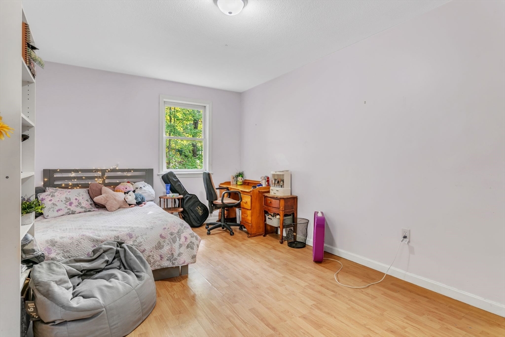 52 Warren Wright Road Belchertown, MA 01007 - Photo 22 of 41 a bedroom with furniture and a wooden floor