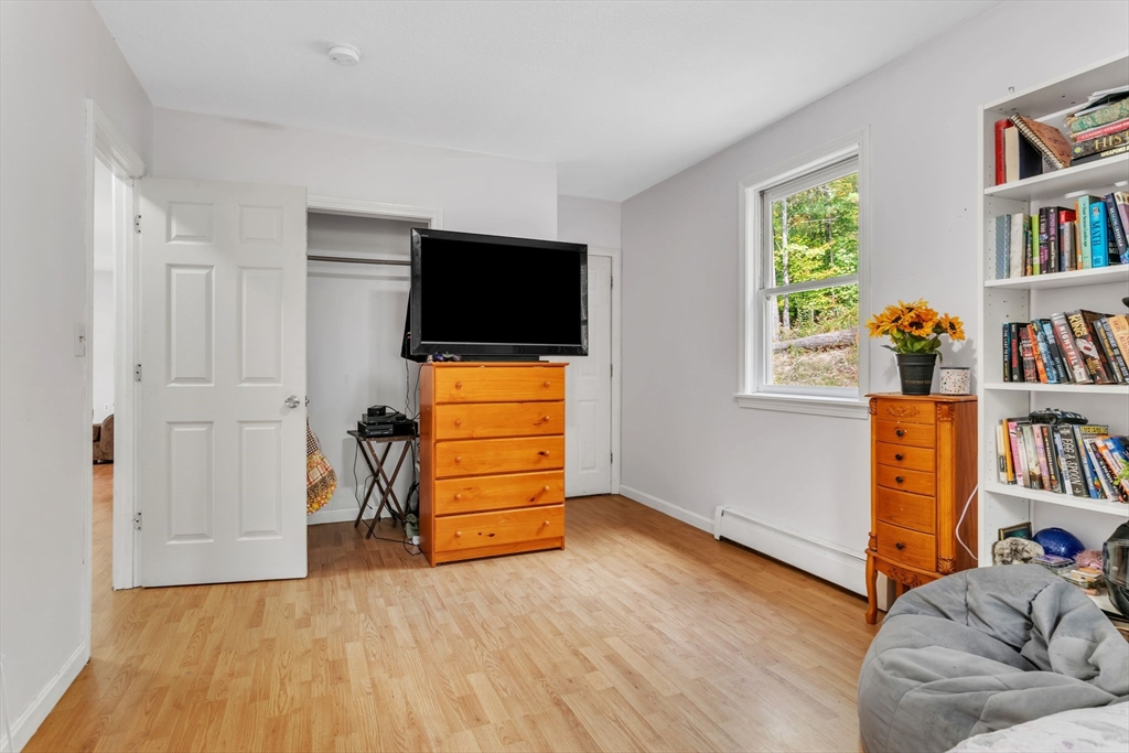 52 Warren Wright Road Belchertown, MA 01007 - Photo 23 of 41 a living room with furniture and a flat screen tv