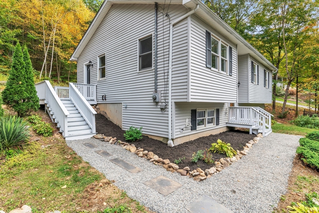 52 Warren Wright Road Belchertown, MA 01007 - Photo 3 of 41 a front view of a house with a yard