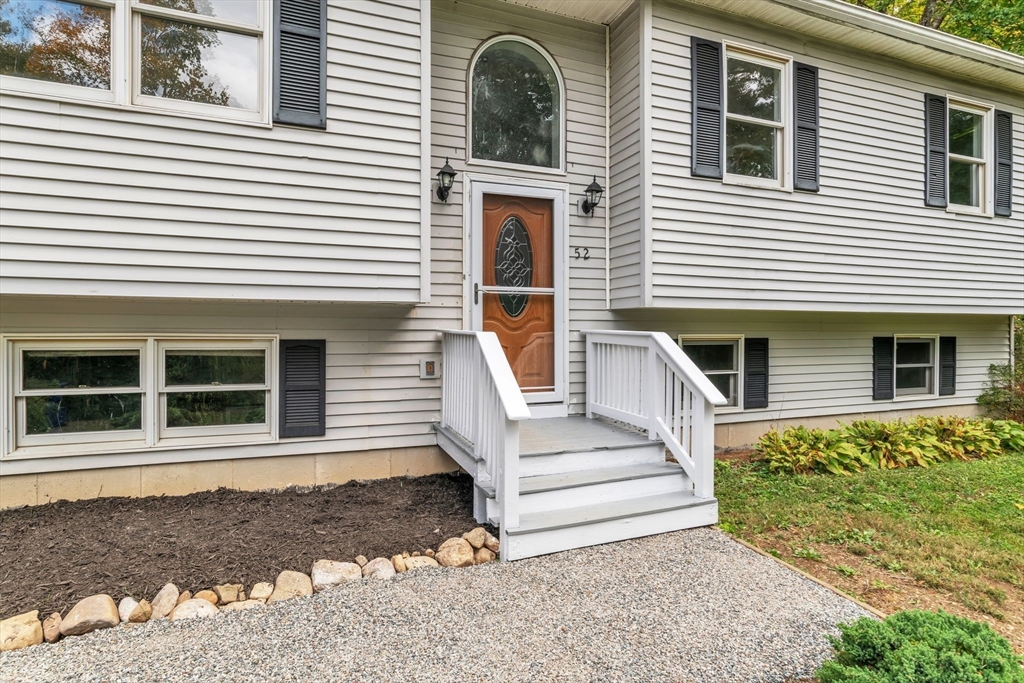 52 Warren Wright Road Belchertown, MA 01007 - Photo 4 of 41 a front view of a house with a yard
