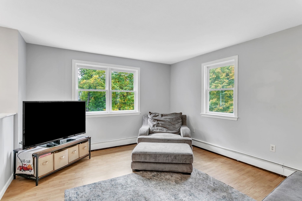 52 Warren Wright Road Belchertown, MA 01007 - Photo 9 of 41 a living room with furniture and a flat screen tv