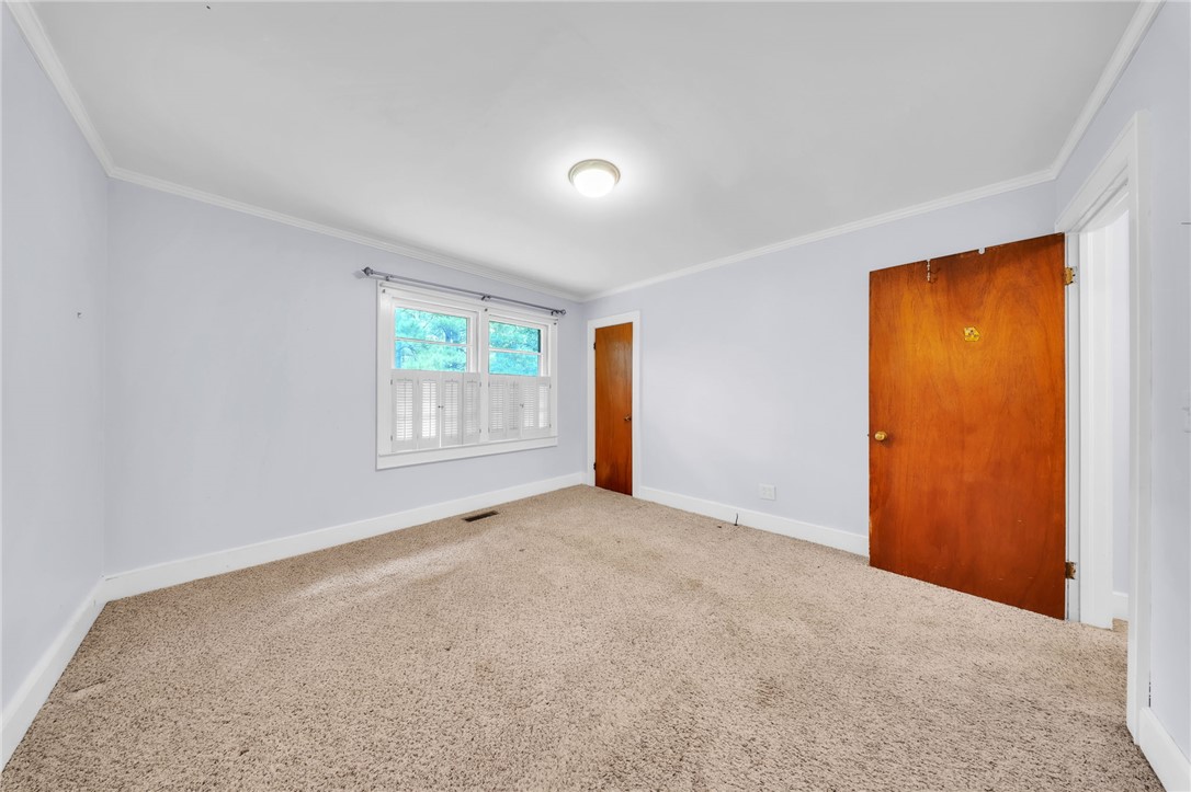 107 Burton Road Anderson, SC 29625 - Photo 18 of 33 Soft carpeting underfoot and classic crown molding define this versatile bedroom space.