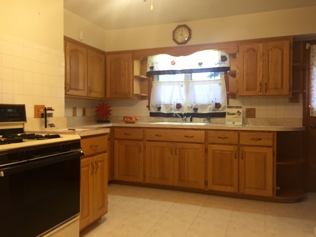 914 Westminster Road Joliet, IL 60435 - Photo 5 of 16 a kitchen with cabinets a window and stainless steel appliances