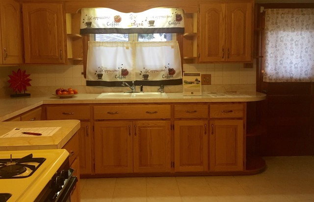 914 Westminster Road Joliet, IL 60435 - Photo 6 of 16 a kitchen with a sink cabinets and wooden floor