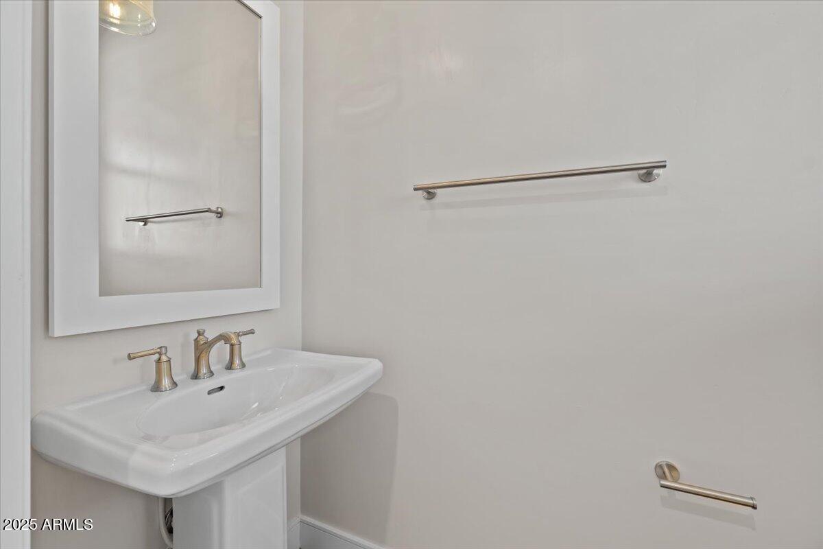 2431 West Los Arboles Place Chandler, AZ 85224 - Photo 10 of 60 a bathroom with a sink and a mirror