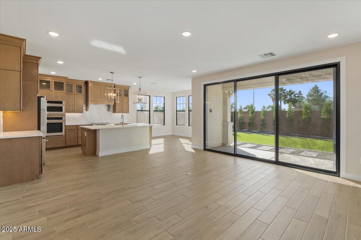 2431 West Los Arboles Place Chandler, AZ 85224 - Photo 13 of 60 a view of a kitchen with a sink and a large window