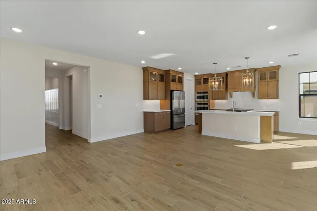 a view of a kitchen with stainless steel appliances granite countertop a stove and a refrigerator