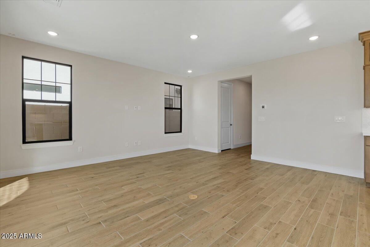 2431 West Los Arboles Place Chandler, AZ 85224 - Photo 15 of 60 a view of an empty room with wooden floor and windows