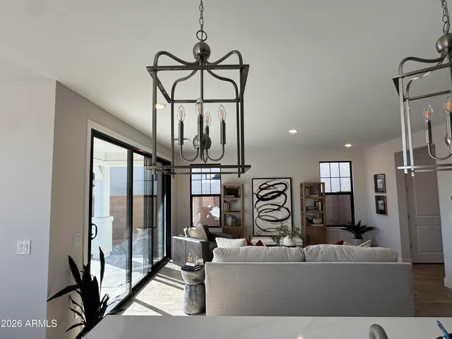 a view of a kitchen with stainless steel appliances granite countertop a stove and a refrigerator