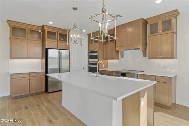 a kitchen with granite countertop a sink stainless steel appliances a large window and cabinets