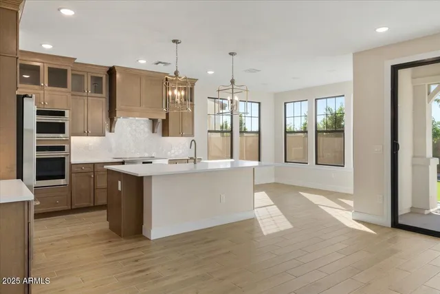 a kitchen with stainless steel appliances a stove and a refrigerator