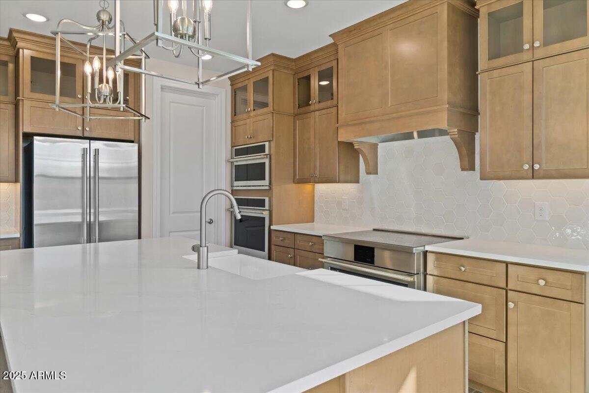 2431 West Los Arboles Place Chandler, AZ 85224 - Photo 19 of 60 a kitchen with stainless steel appliances a stove and a refrigerator
