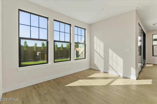 wooden floor in an empty room with windows